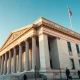 U.S. Treasury Department building in Washington, D.C., on a sunny afternoon.