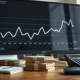 Financial analyst's desk with a monitor showing rising US Treasury yield chart and bonds