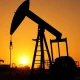 Oil pump jack silhouetted against a sunset, representing WTI crude oil price movements.