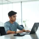 Young founder working on laptop in a San Francisco startup office