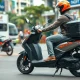 Electric two-wheeler scooter on a Bengaluru street, representing Yulu's fleet expansion