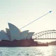 Sydney skyline with Opera House and Harbour Bridge under clear morning light, representing Australia's economic growth in Q2 2026.