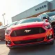 New Ford Mustang, Ranger, and Bronco Sport vehicles lined up at a dealership lot for Autonomy's subscription fleet.