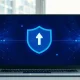 Laptop displaying a browser update interface with a large circular arrow and shield icon, symbolizing Chrome's new two-week release cycle.