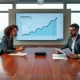 Enterprise executives reviewing declining revenue charts in a modern boardroom