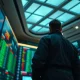 Trader watching a falling stock chart on a trading floor ticker board
