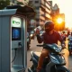 An electric two-wheeler rider swapping a battery at a Yuma Energy station in India