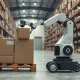 Warehouse robot with two arms stacking boxes onto a mixed pallet at a distribution center