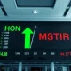 Stock market display board showing Honeywell and Strategy stock movements on Nasdaq 100
