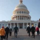 Workers walk toward the U.S. Capitol as debate over Bernie Sanders' 32-hour workweek proposal intensifies.