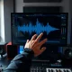 Suno v6 AI music interface displayed on a studio monitor with a producer at the mixing console