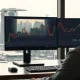 Analyst monitors USD/SGD chart with Singapore skyline in background