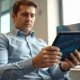 Analyst reviewing financial charts on tablet in office setting