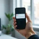Person holding smartphone with email notification, representing password reset attacks on X after X Money launch