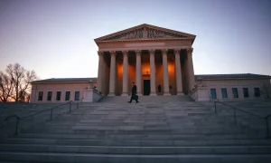 Official walking toward a federal regulator's building at dusk in Washington, D.C.